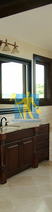 traditional bathroom with shiny stone tiles and mosaic bath tub sides wooden cabinets Adelaide/Playford