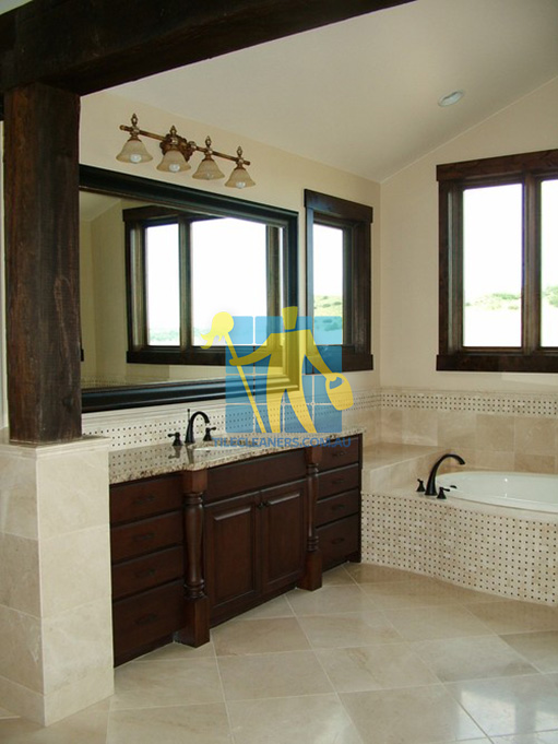 traditional bathroom with shiny stone tiles and mosaic bath tub sides wooden cabinets Belmont