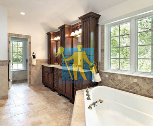 traditional bathroom with stone like tiles on floors and walls and bathtub Belmont