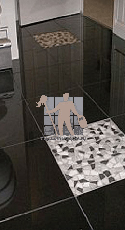 polished granite tile floor in bathroom black with one white tile Sydney/The Hills/Arcadia