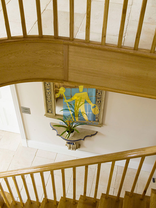 Belmont marble tile tumbled acru hallway under wooden staircase