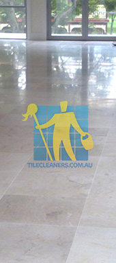 travertine tiles in large empty livingtoom large tiles after cleaning with machines in back Canberra/Molonglo Valley