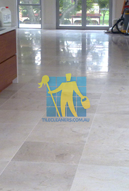 travertine tiles in large empty livingtoom large tiles after cleaning with machines in back Canberra/Weston Creek