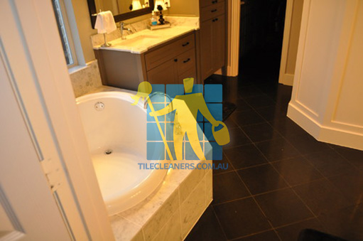 traditional bathroom with black granite tiles on the floor